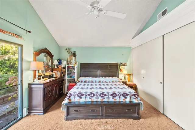 a view of a chair and table in backyard of the house