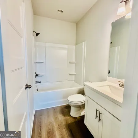 a bathroom with a double vanity sink mirror and shower