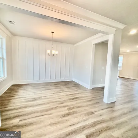 a view of a livingroom with wooden floor and staircase