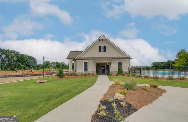 a view of a chairs and table in front of house