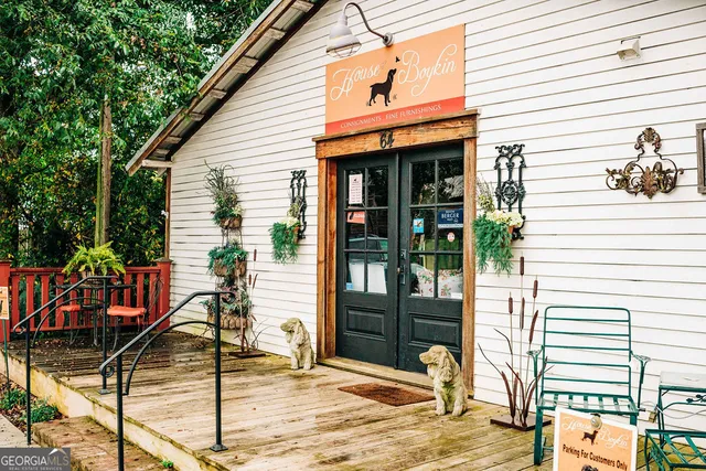 a front view of a building with cars parked