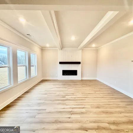 a view of a kitchen with kitchen island white cabinets and wooden floor