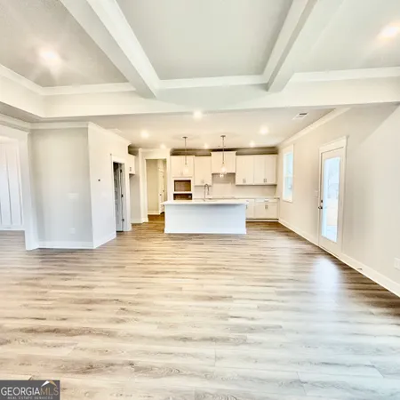 a kitchen with kitchen island white cabinets and stainless steel appliances