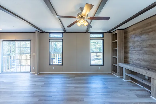 a kitchen with stainless steel appliances granite countertop a stove a sink and a microwave with wooden floor