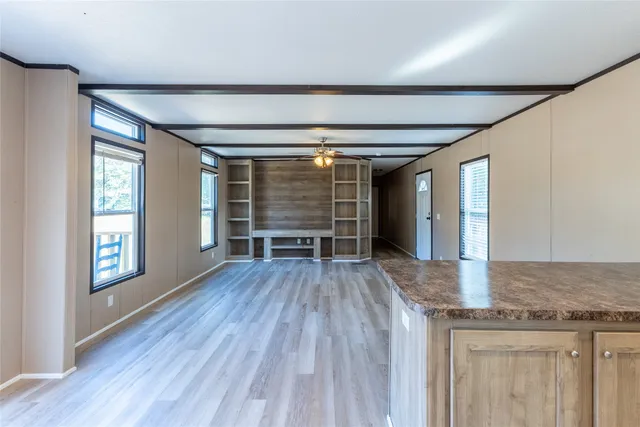 a view of a kitchen with a sink and dishwasher with wooden floor