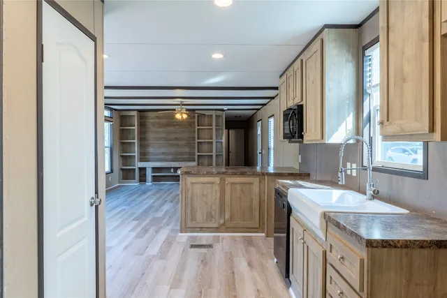 a kitchen with stainless steel appliances granite countertop a sink stove and cabinets