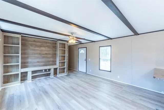 an empty room with windows and closet