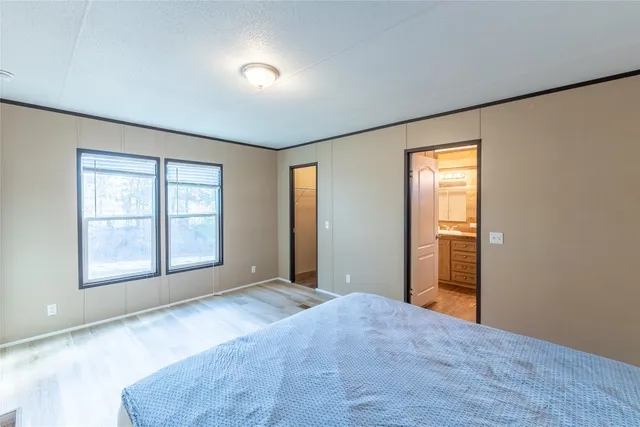 an empty room with windows and closet