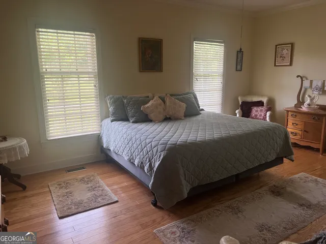 a bedroom with a bed rug and window