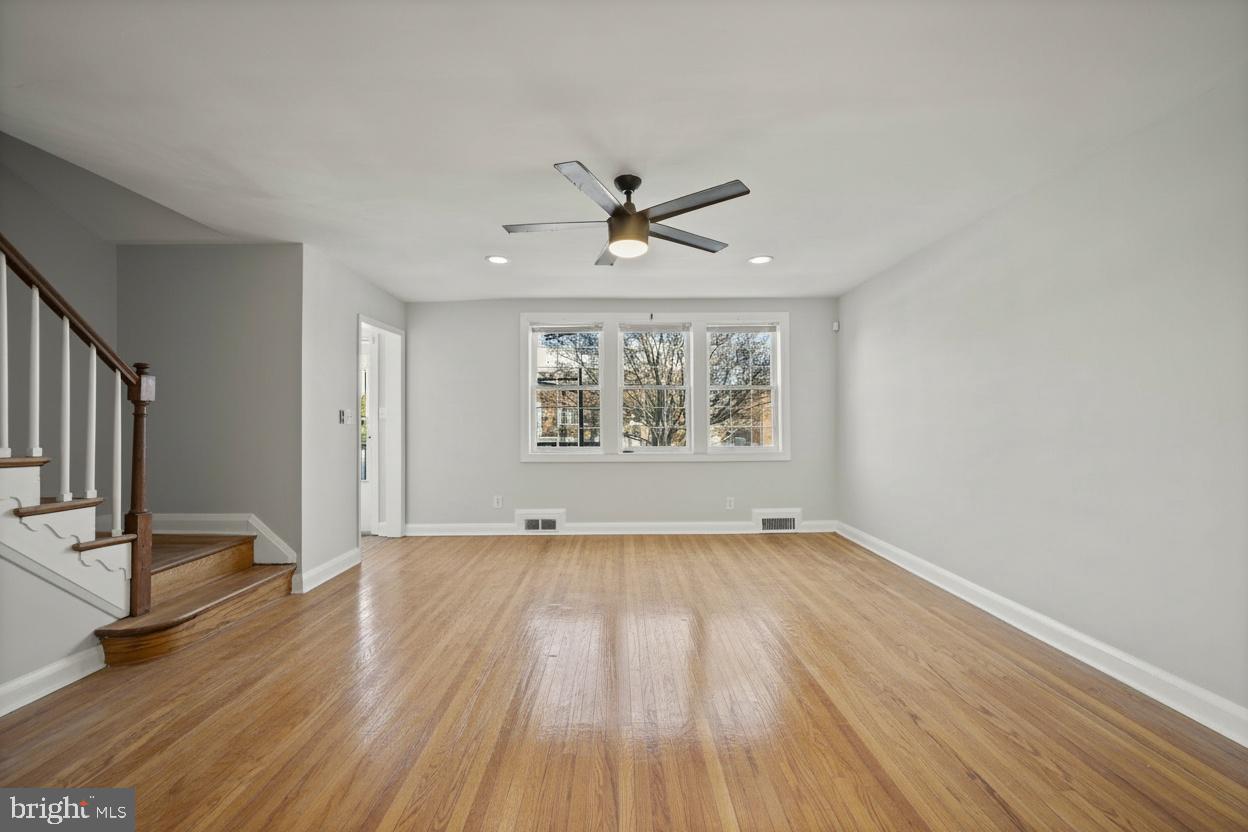 1807 Deveron Road Towson, MD 21286 - Photo 3 of 33 an empty room with wooden floor chandelier fan and windows