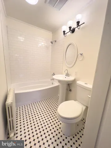 a bathroom with a toilet a sink and a mirror