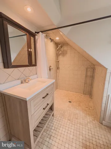 a bathroom with a sink a mirror and a shower