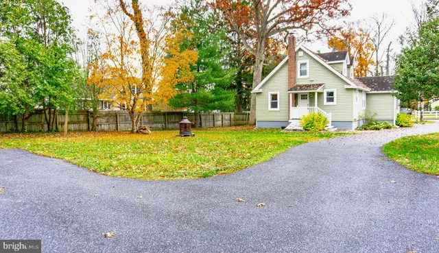 a view of a house with a swimming pool and a yard