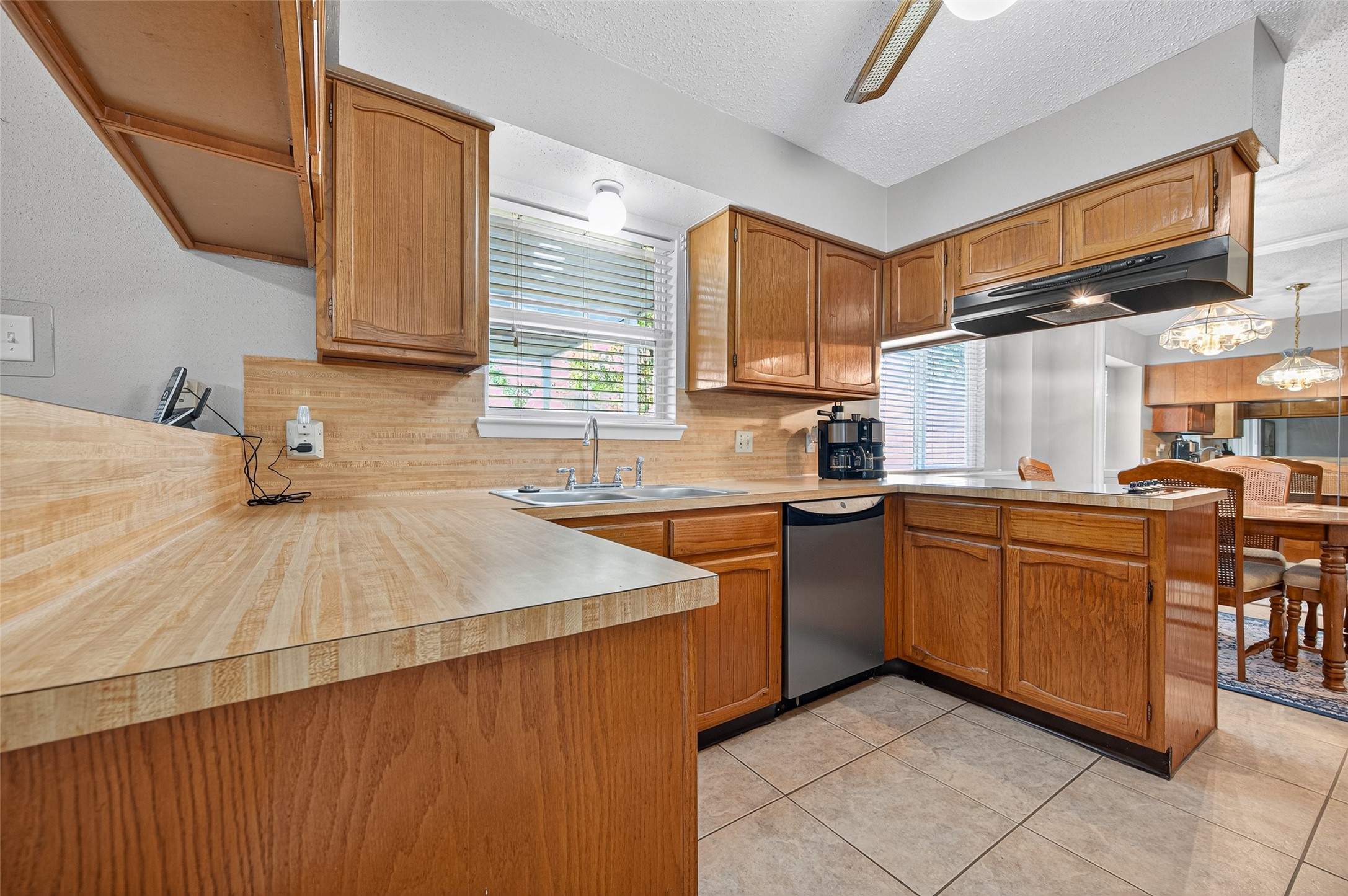 6230 Sunnygate Drive Spring, TX 77373 - Photo 11 of 40 a kitchen with stainless steel appliances a sink dishwasher stove refrigerator and cabinets