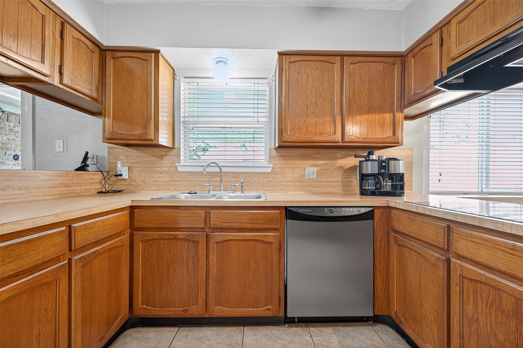 6230 Sunnygate Drive Spring, TX 77373 - Photo 12 of 40 a kitchen with stainless steel appliances granite countertop a sink and a cabinets