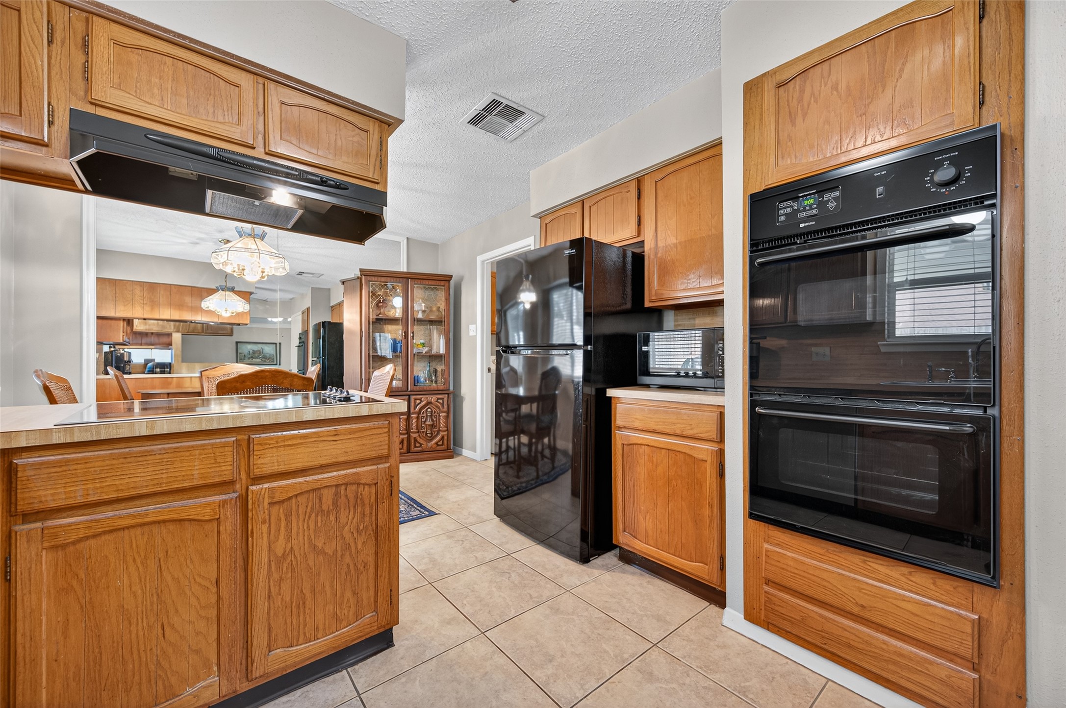 6230 Sunnygate Drive Spring, TX 77373 - Photo 16 of 40 a kitchen with stainless steel appliances granite countertop a refrigerator and a stove top oven