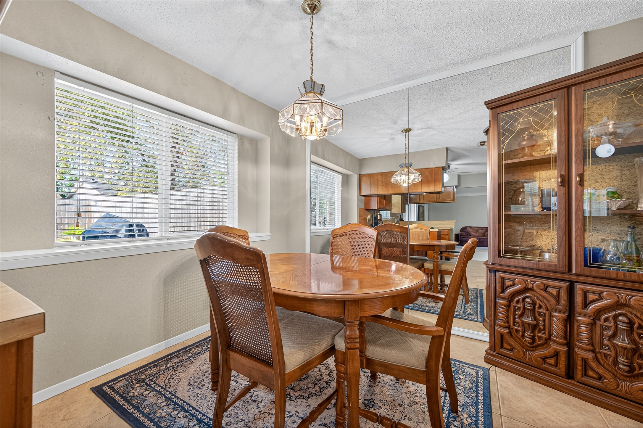 6230 Sunnygate Drive Spring, TX 77373 - Photo 18 of 40 a dining room with furniture a chandelier and wooden floor