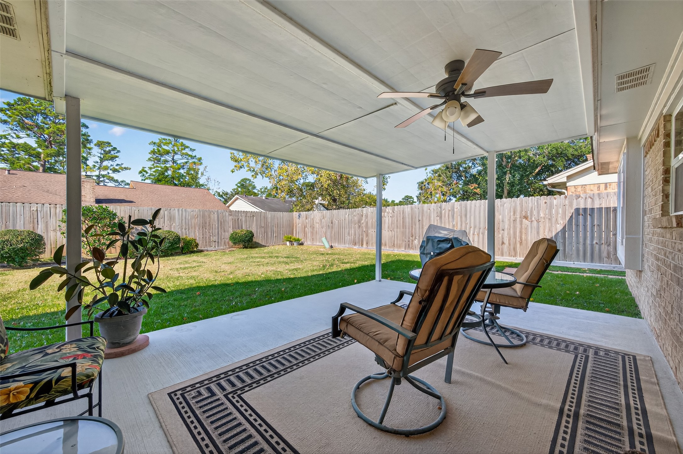 6230 Sunnygate Drive Spring, TX 77373 - Photo 33 of 40 a view of a patio with a table chairs and a yard