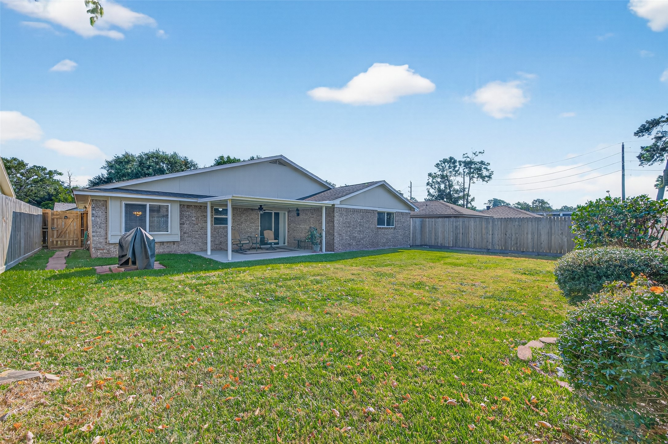 6230 Sunnygate Drive Spring, TX 77373 - Photo 37 of 40 a view of a house with a backyard and a patio
