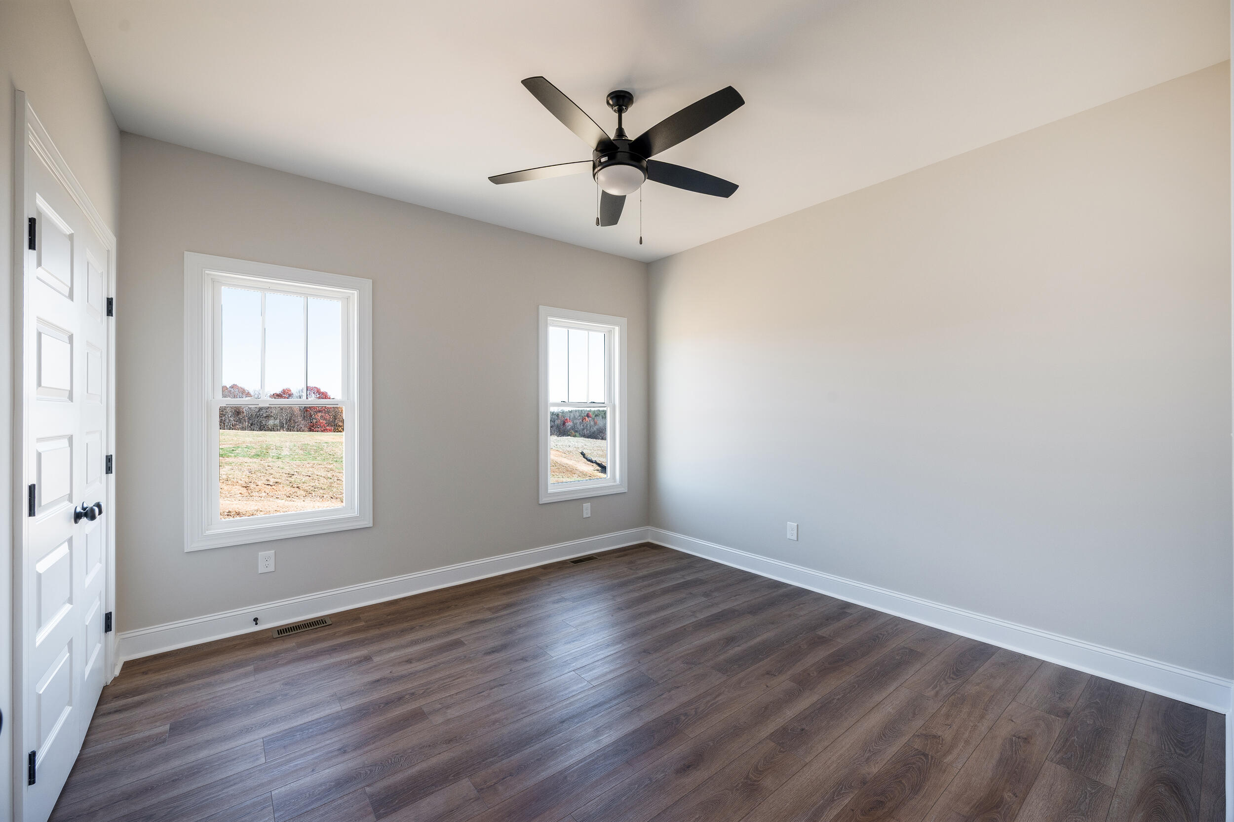 10510 Leesville Road Lynch Station, VA 24571 - Photo 35 of 60 an empty room with wooden floor fan and windows