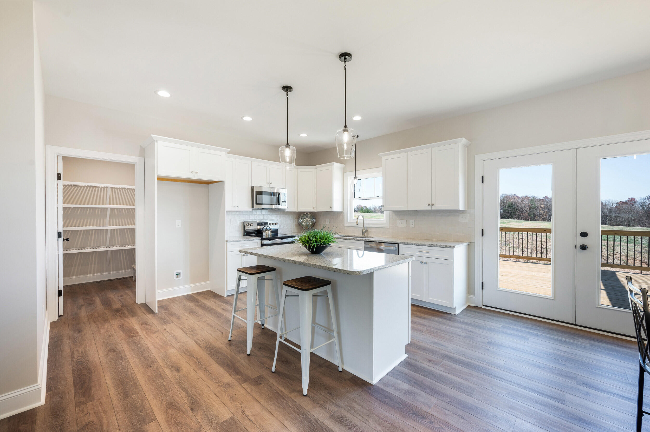 10510 Leesville Road Lynch Station, VA 24571 - Photo 10 of 60 a kitchen with stainless steel appliances granite countertop a table chairs refrigerator and sink