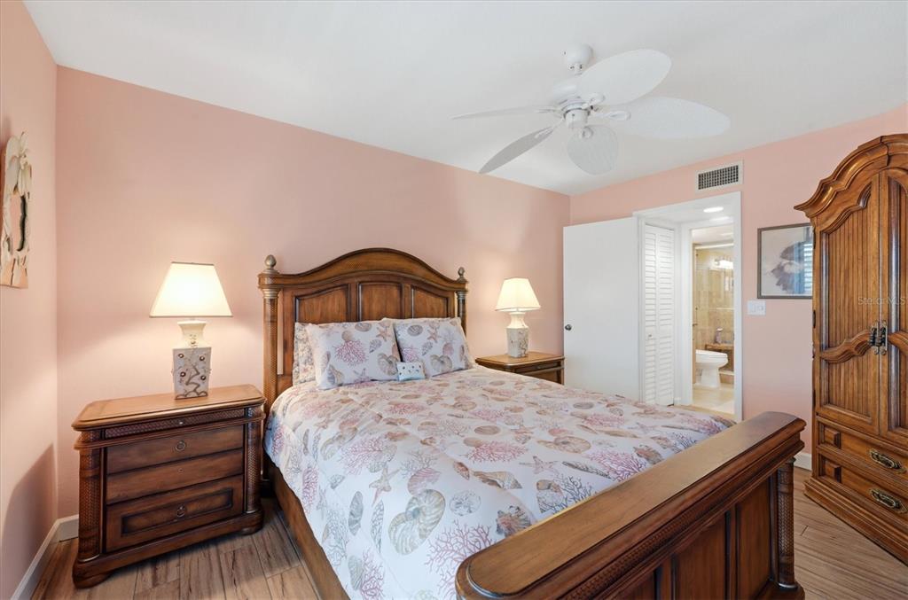 2729 North Beach Road, Unit 211 Englewood, FL 34223 - Photo 31 of 51 a bedroom with a bed and a chandelier