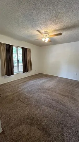 a view of an empty room with large windows