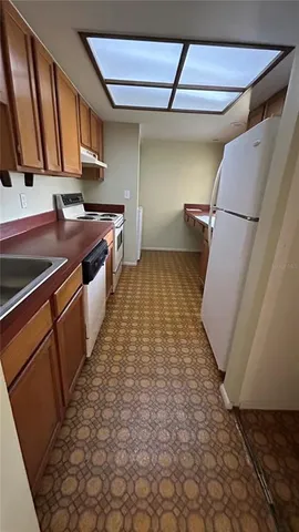 a kitchen with a sink and wooden cabinets