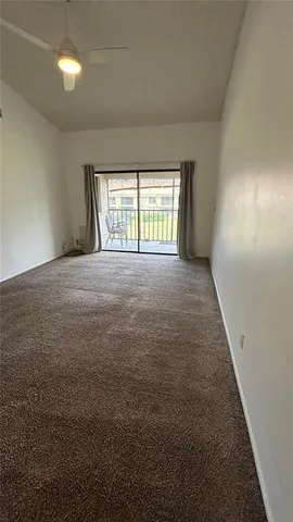 en empty room with windows and entrance