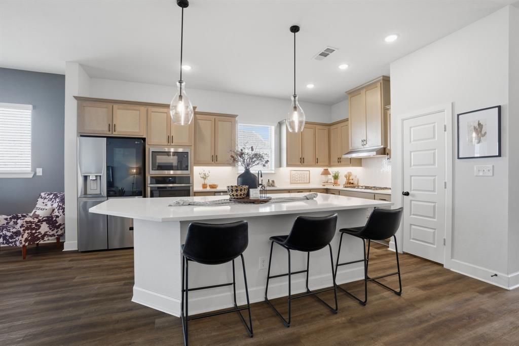 1632 Cotton Road Van Alstyne, TX 75495 - Photo 7 of 40 a kitchen with stainless steel appliances kitchen island granite countertop a dining table chairs sink and cabinets
