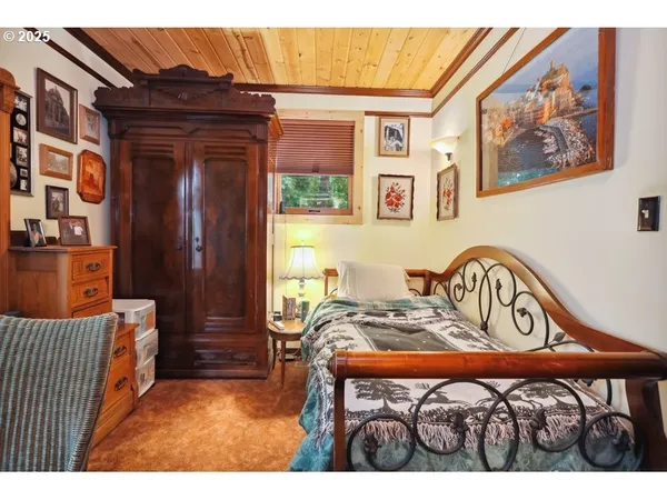a bedroom with a bed and a painting on the wall
