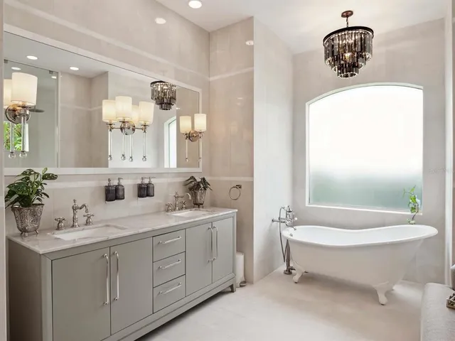 a bathroom with a double vanity sink mirror and bathtub