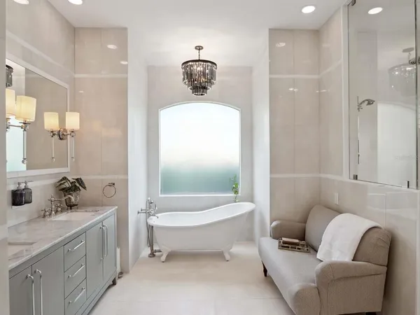 a bathroom with a toilet a sink a mirror a bathtub and shower