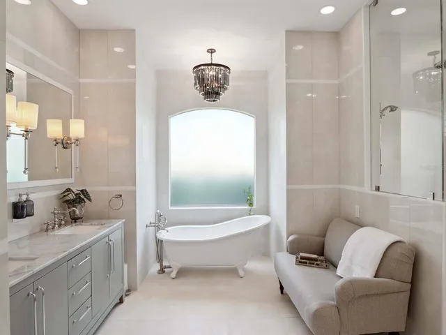 a bathroom with a toilet a sink a mirror a bathtub and shower