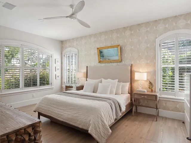 a bedroom with a bed a stove and a large window