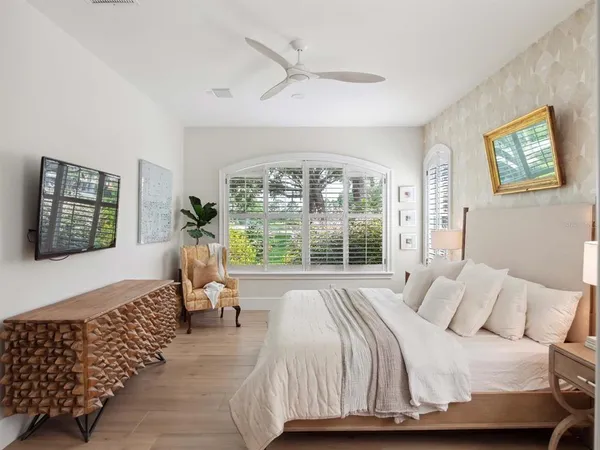 a bedroom with a bed and a large window