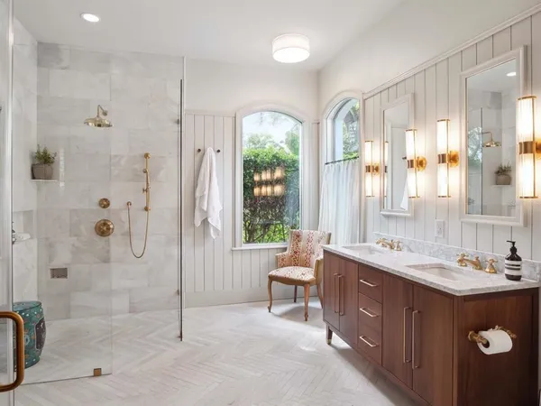 a spacious bathroom with a double vanity sink toilet and shower