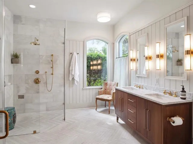 a spacious bathroom with a double vanity sink toilet and shower