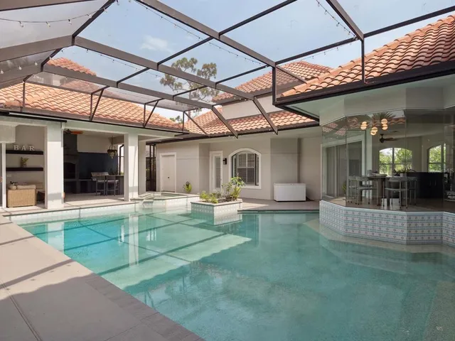 a view of a house with backyard porch and sitting area
