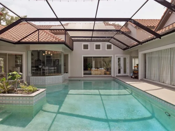a view of a white building with swimming pool in front of it