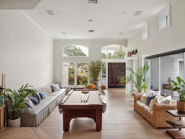 a living room with furniture a chandelier and a fireplace