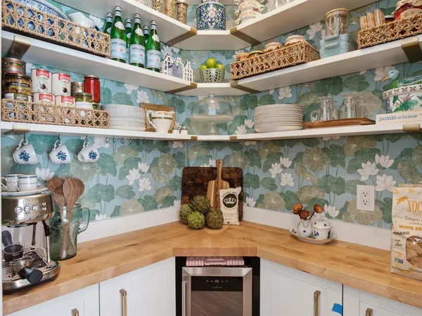 a kitchen area with granite countertop lots of different kinds of food