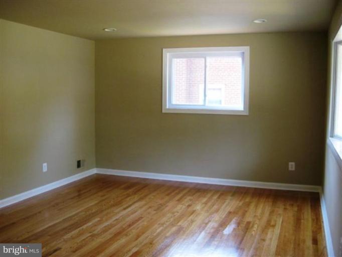 408 Hannes Street Silver Spring, MD 20901 - Photo 3 of 10 a view of a room with wooden floor and windows