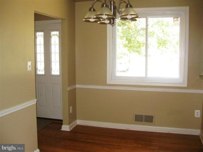 408 Hannes Street Silver Spring, MD 20901 - Photo 6 of 10 a view of an empty room with wooden floor and a window
