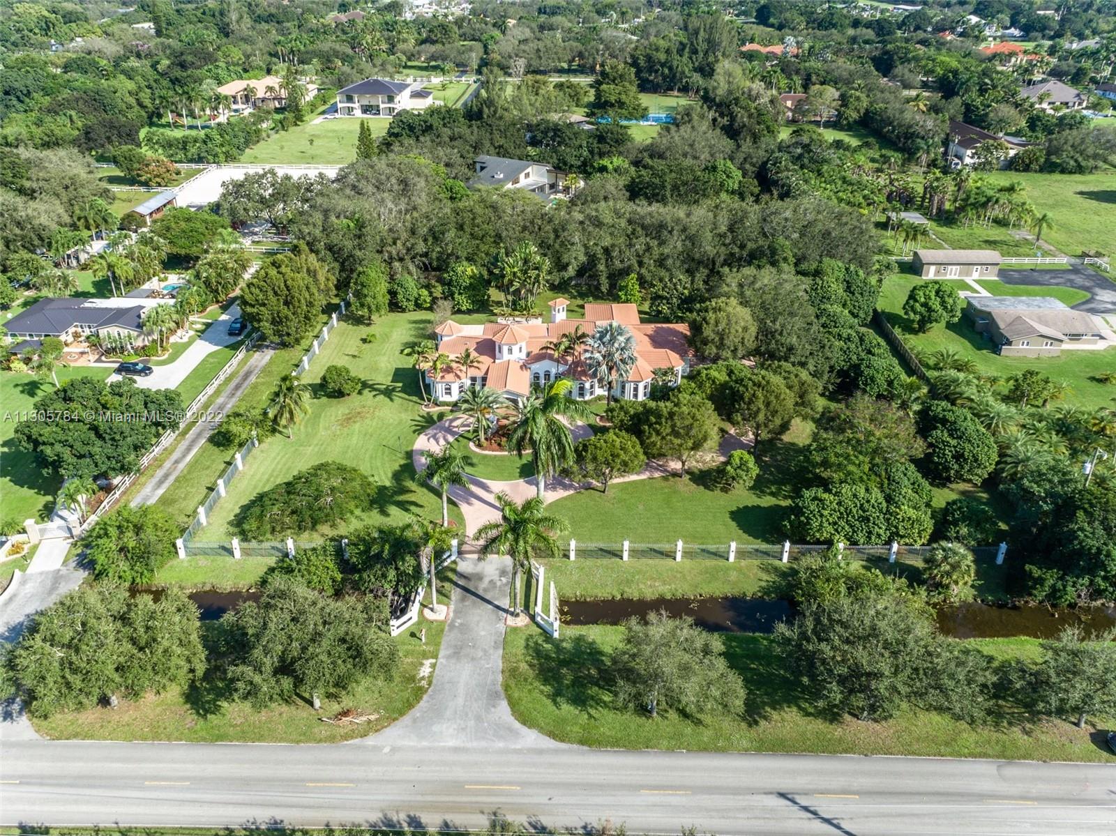 an aerial view of a house with a yard and outdoor seating