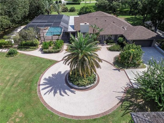 an aerial view of a house with a garden and a yard