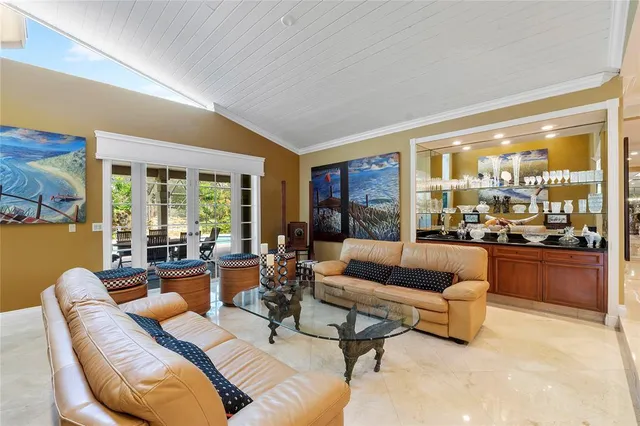 a kitchen with stainless steel appliances granite countertop a white cabinets and chairs