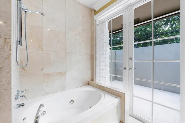 a spacious bathroom with sinks mirror and a bathtub