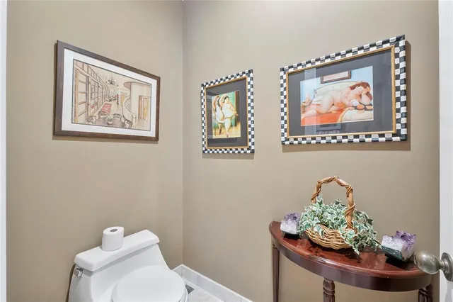 a bathroom with a toilet a sink and a mirror