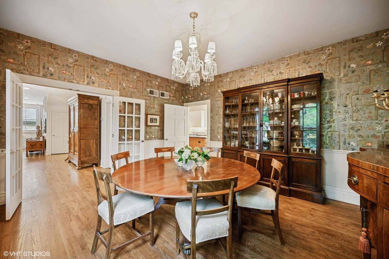 475 Maple Street Winnetka, IL 60093 - Photo 21 of 52 a dining room with wooden floor a chandelier a wooden table and chairs